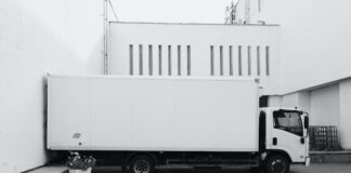 A black and white image of a white box truck for a transportation business that utilizes self-service BI.